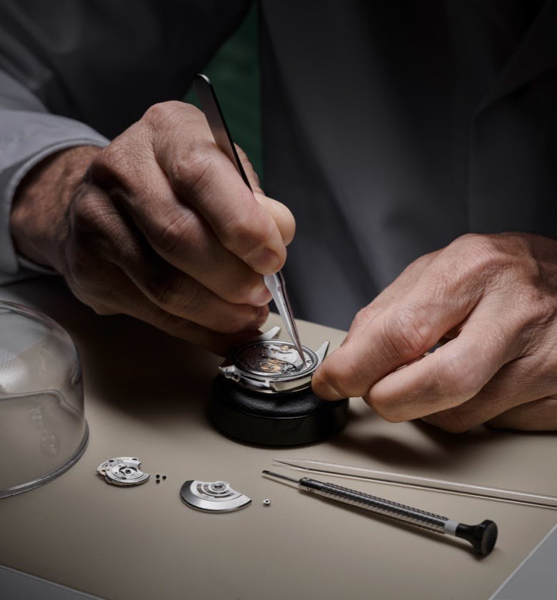 Photo of a watchmaker servicing a Rolex watch
