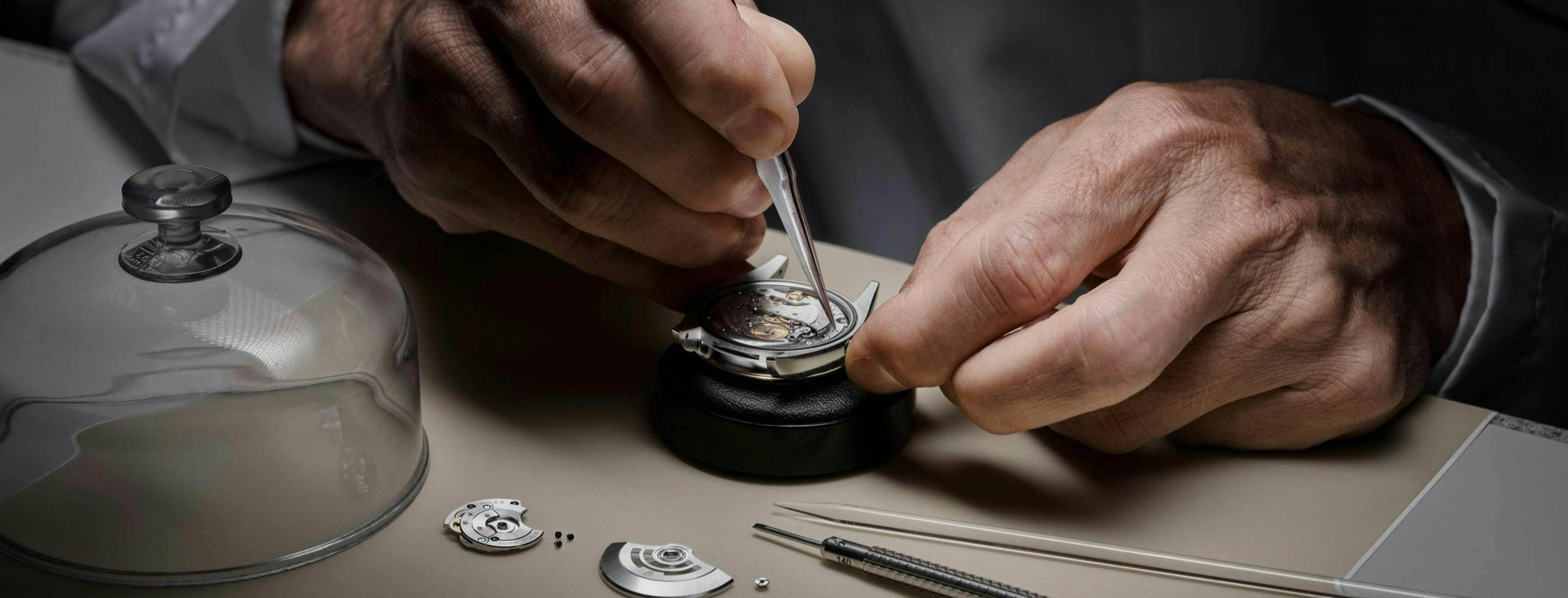Photo of a watchmaker servicing a Rolex watch