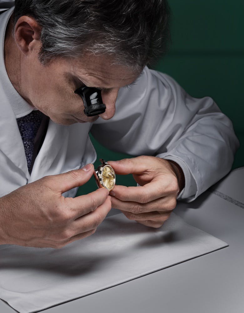 Photo of a Rolex watchmaker inspecting a watch