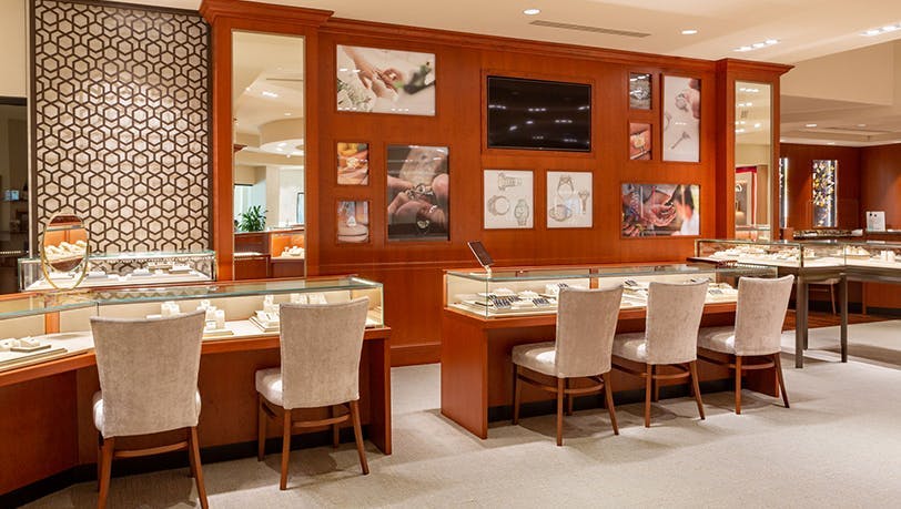 Lee Michaels Fine Jewelry showroom featuring multiple glass display cases, seating for trying on jewelry and store displays of best selling styles.